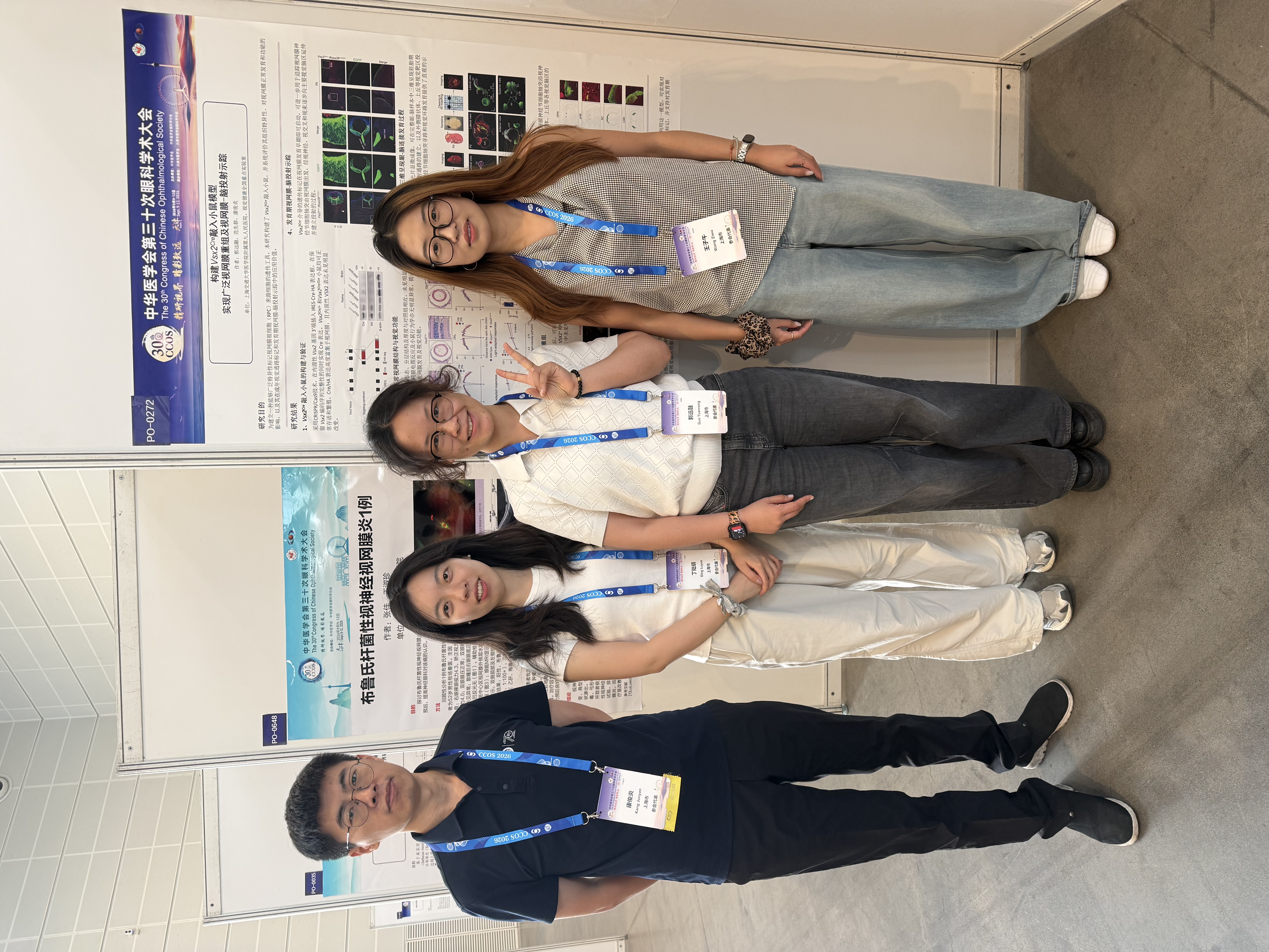 Four Kang Lab members together in the poster exhibition area at CCOS2026